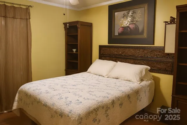 a bedroom with a bed and painting on the wall