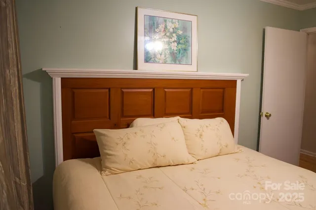 a bed sitting in a bedroom next to a window