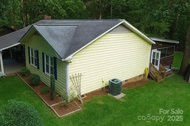 a view of backyard with a deck and garden