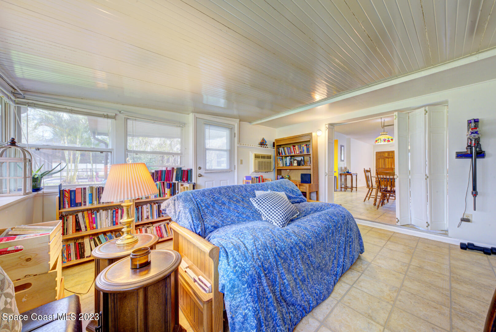 2180 Cindy Circle Melbourne, FL 32935 - Photo 13 of 31 a living room with furniture a chandelier fan and a rug