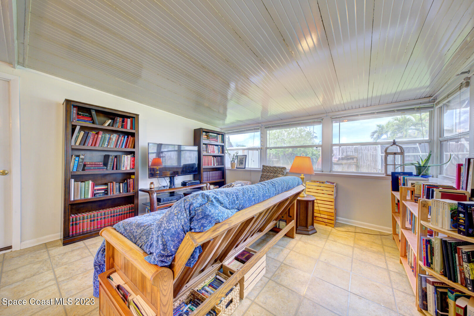 2180 Cindy Circle Melbourne, FL 32935 - Photo 14 of 31 a living room with lots of furniture and a book shelf
