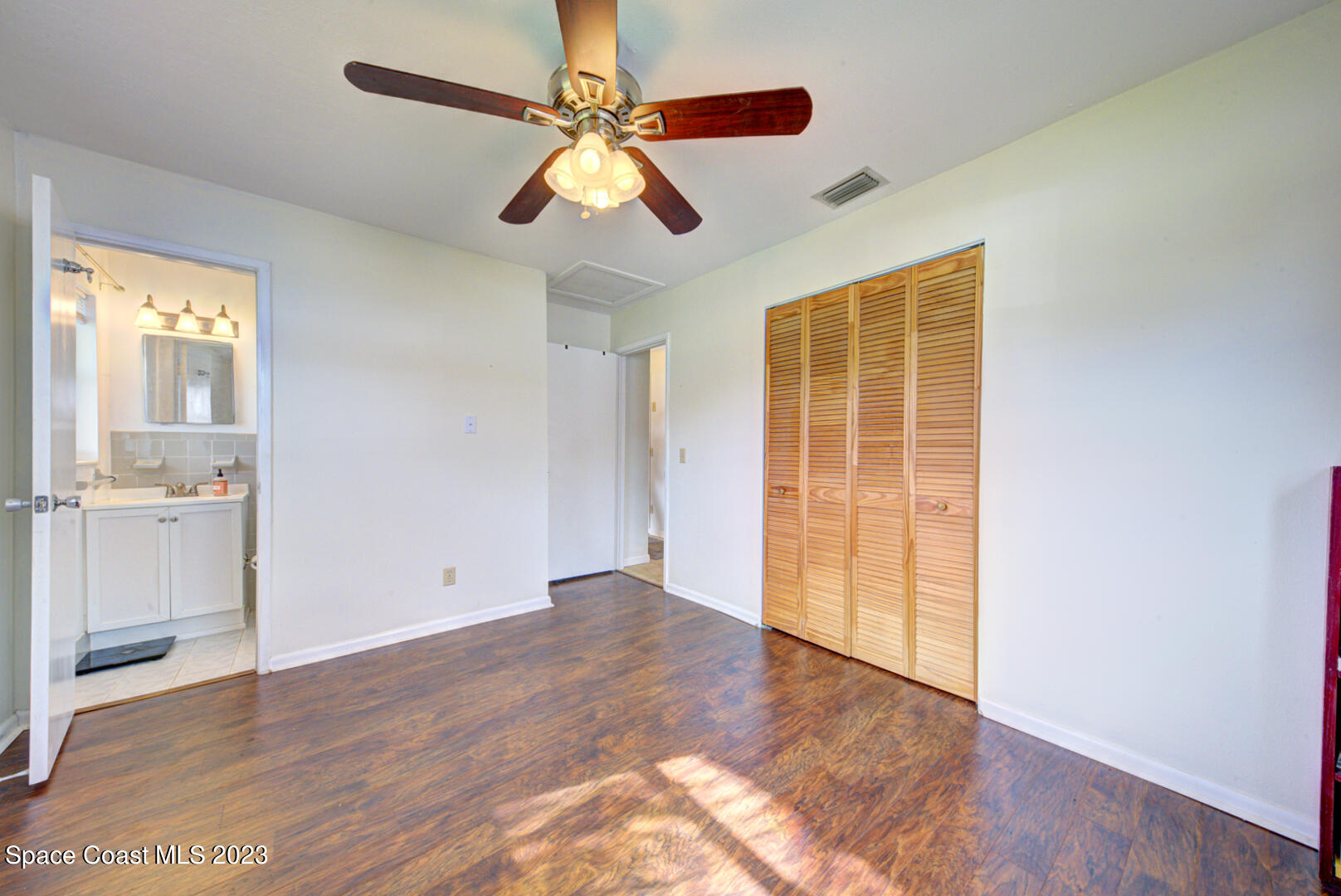 2180 Cindy Circle Melbourne, FL 32935 - Photo 16 of 31 a view of an empty room with wooden floor and a window