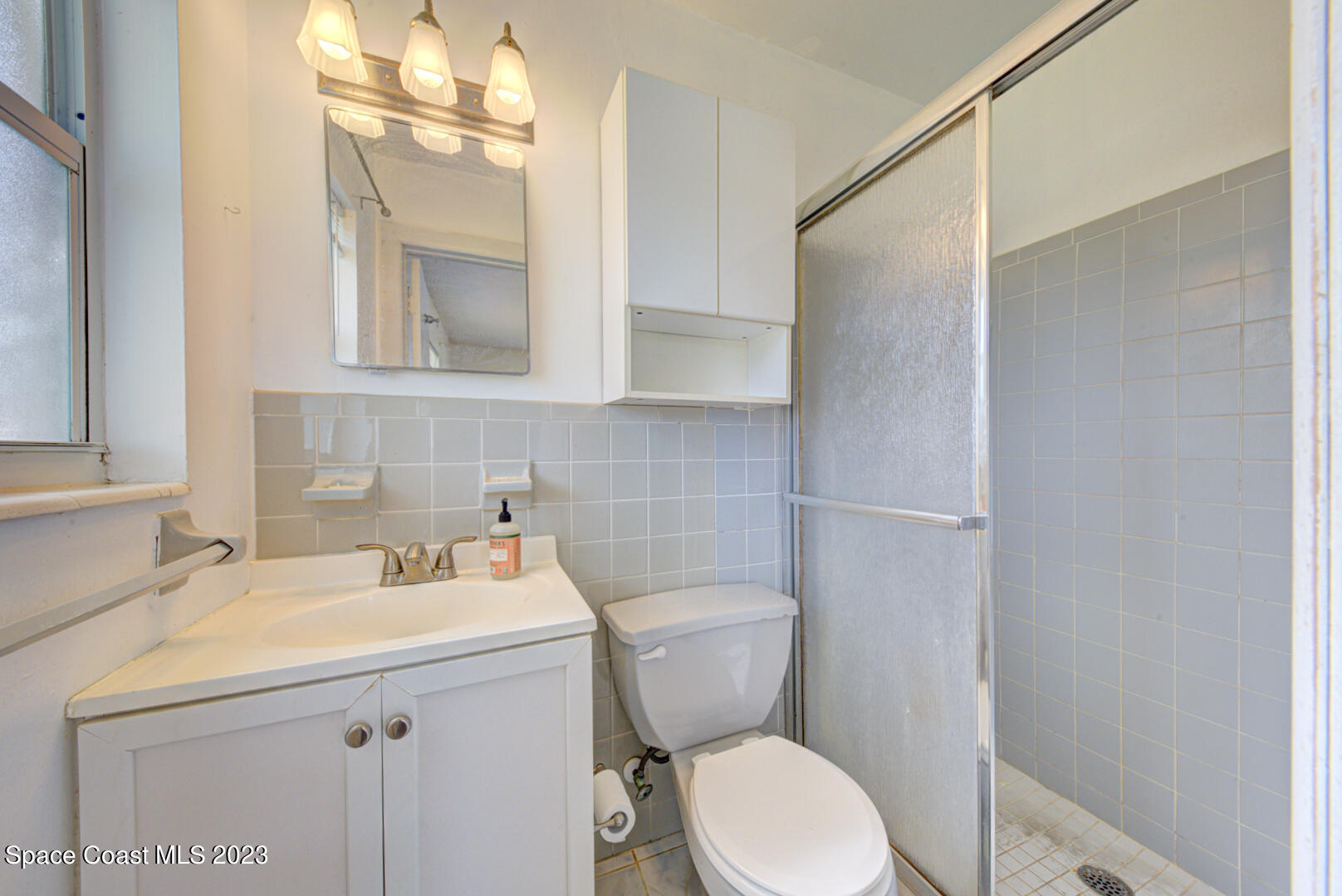 2180 Cindy Circle Melbourne, FL 32935 - Photo 18 of 31 a bathroom with a sink a toilet and mirror