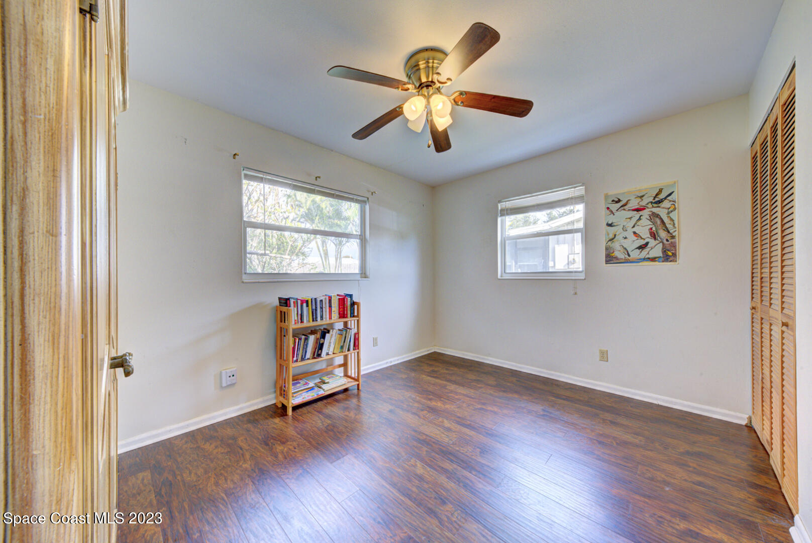 2180 Cindy Circle Melbourne, FL 32935 - Photo 19 of 31 an empty room with wooden floor and windows