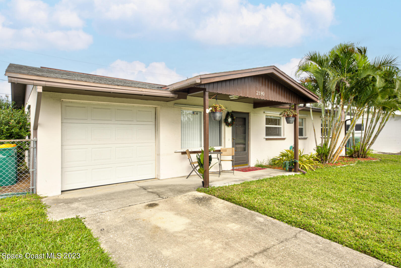 2180 Cindy Circle Melbourne, FL 32935 - Photo 2 of 31 a front view of a house with a yard and garage