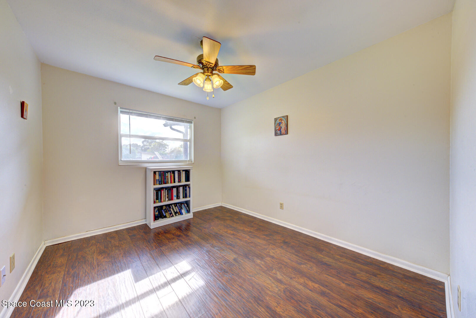2180 Cindy Circle Melbourne, FL 32935 - Photo 22 of 31 wooden floor in an empty room with a window