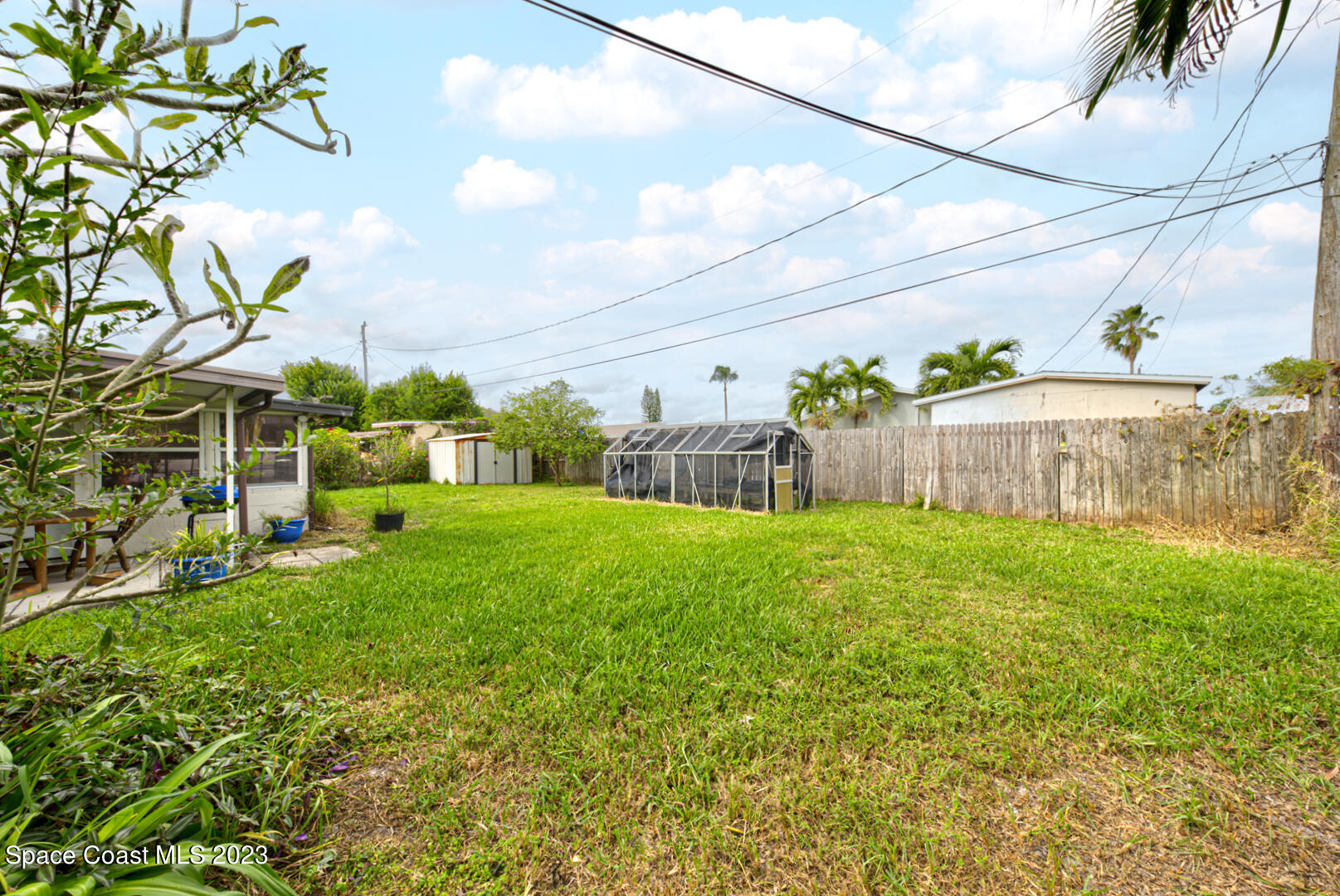 2180 Cindy Circle Melbourne, FL 32935 - Photo 25 of 31 a view of a garden with a tree in the background