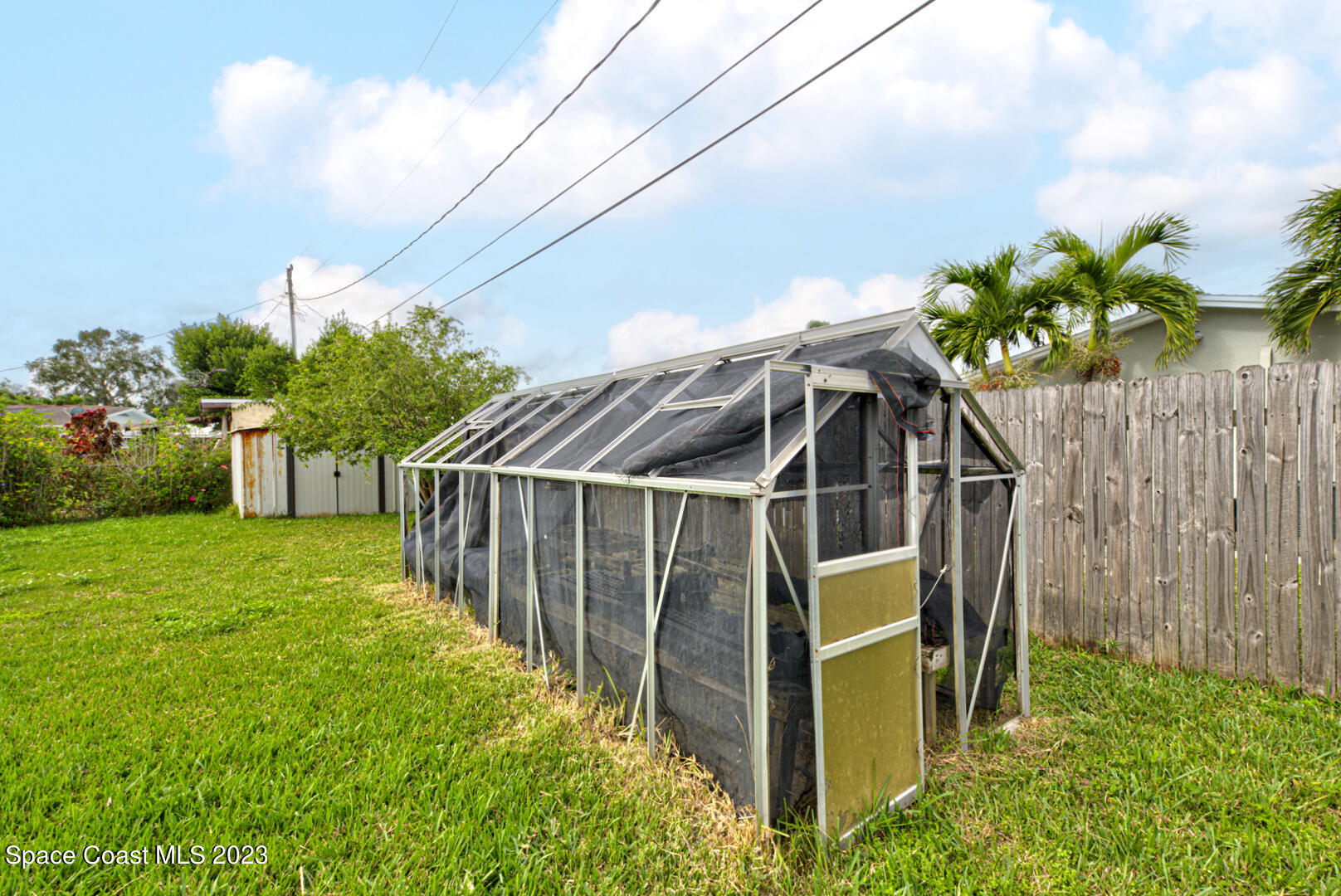 2180 Cindy Circle Melbourne, FL 32935 - Photo 27 of 31 a view of a house with a small yard and wooden fence