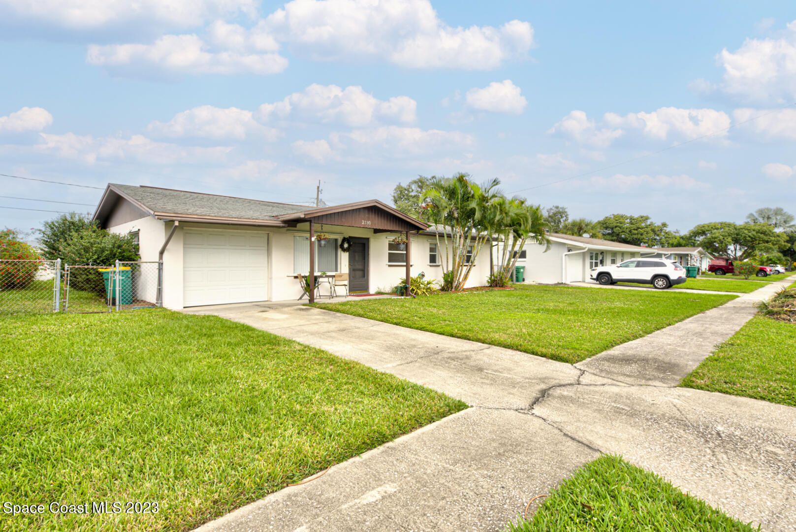 2180 Cindy Circle Melbourne, FL 32935 - Photo 29 of 31 a view of a white house with a big yard and large tree