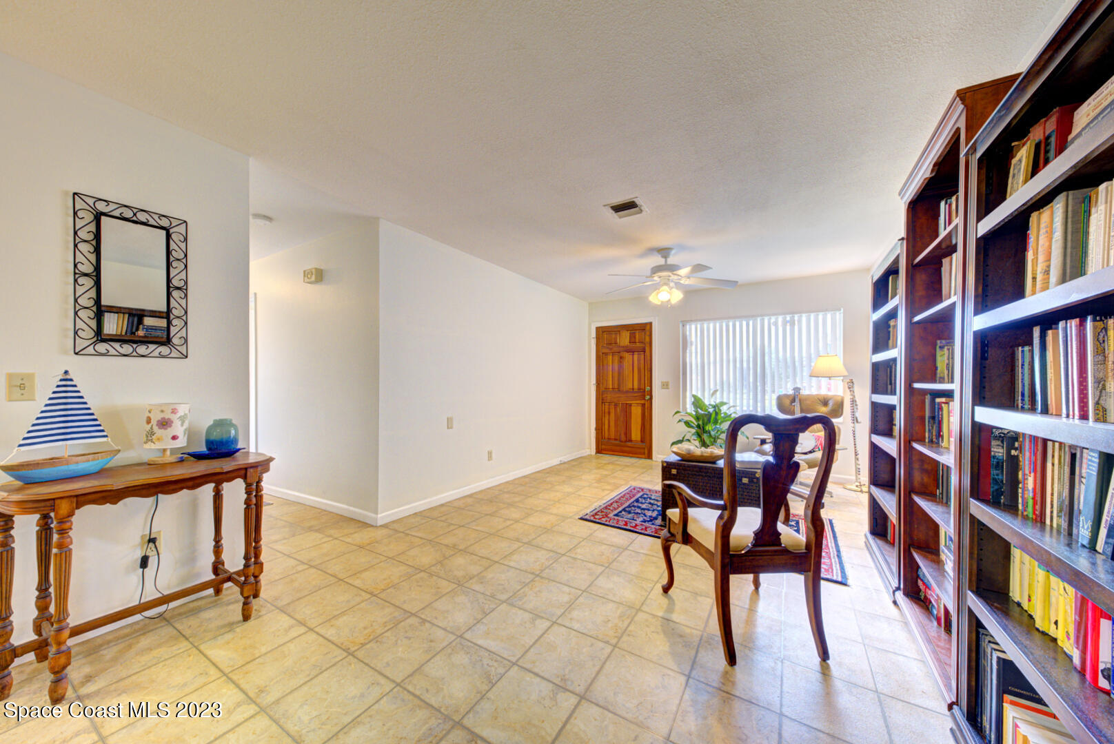 2180 Cindy Circle Melbourne, FL 32935 - Photo 6 of 31 a living room with furniture and a book shelf