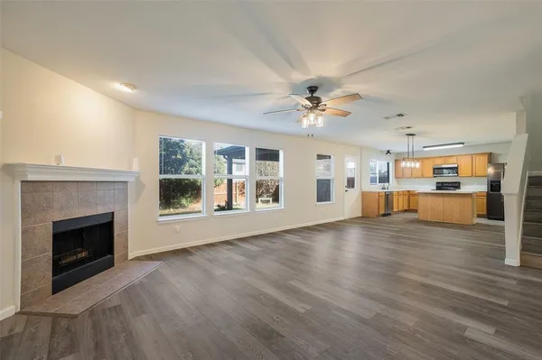 a view of empty room with wooden floor and fireplace