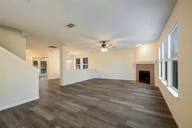 a view of empty room with wooden floor and fireplace