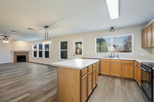 a kitchen with stainless steel appliances granite countertop a sink and stove