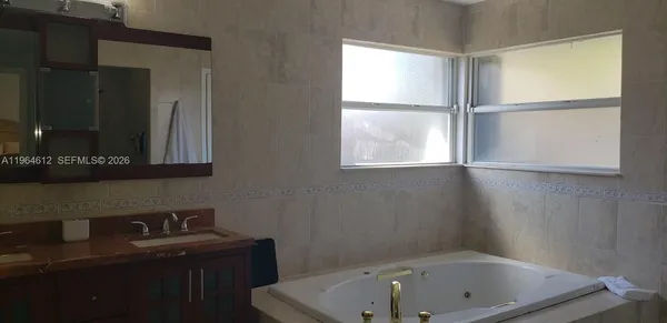 a bathroom with a bathtub and a window