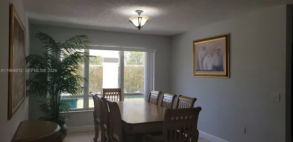 a view of a dining room with furniture window and outside view