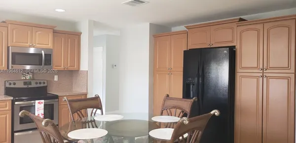 a kitchen with stainless steel appliances a refrigerator and a sink