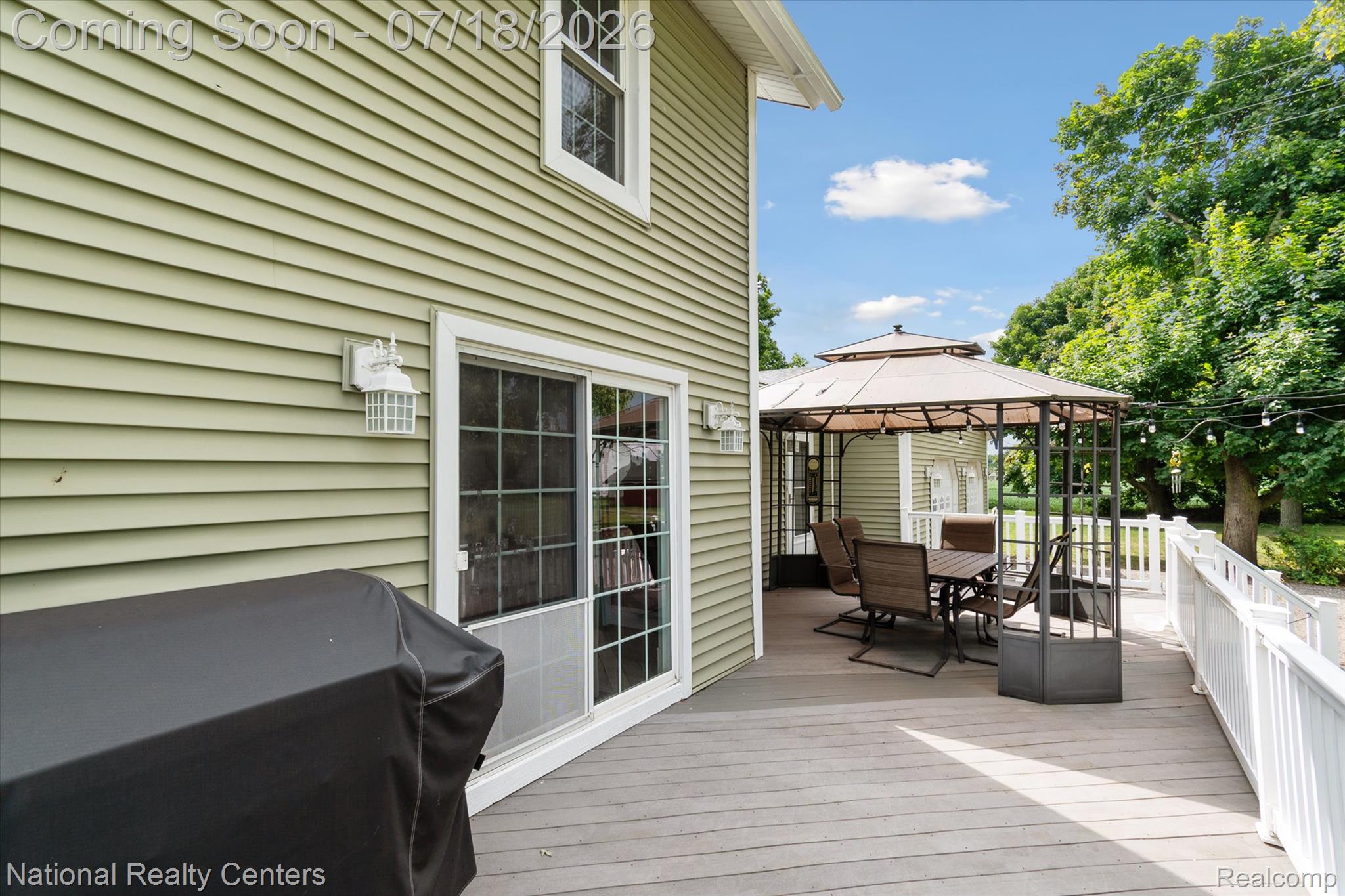 9589 Clinton Macon Road Tecumseh, MI 49286 - Photo 36 of 48 Spacious outdoor deck featuring composite decking, white railing, and a covered gazebo with dining furniture
