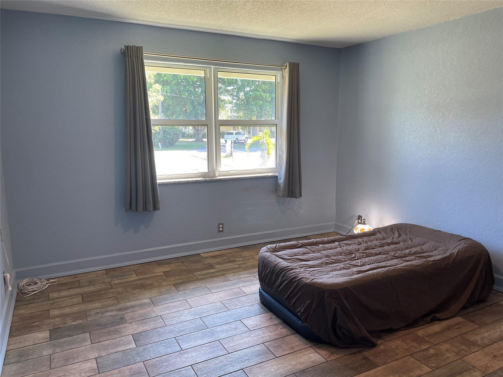 17001 Southwest 48th Street Southwest Ranches, FL 33331 - Photo 13 of 35 a bedroom with a bed and a window