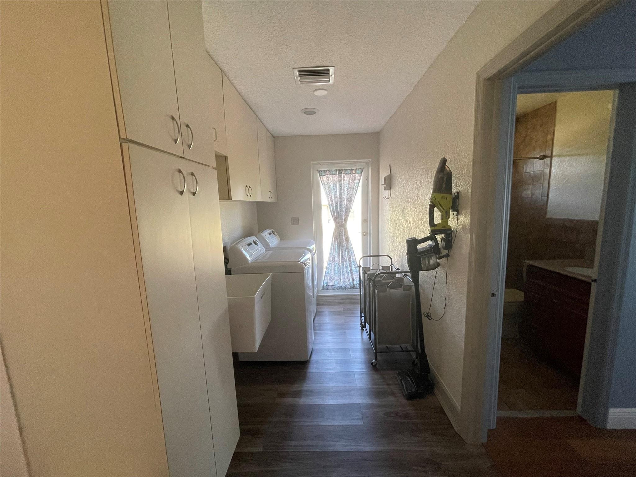 17001 Southwest 48th Street Southwest Ranches, FL 33331 - Photo 23 of 35 a view of a refrigerator in kitchen and an empty room with wooden floor windows