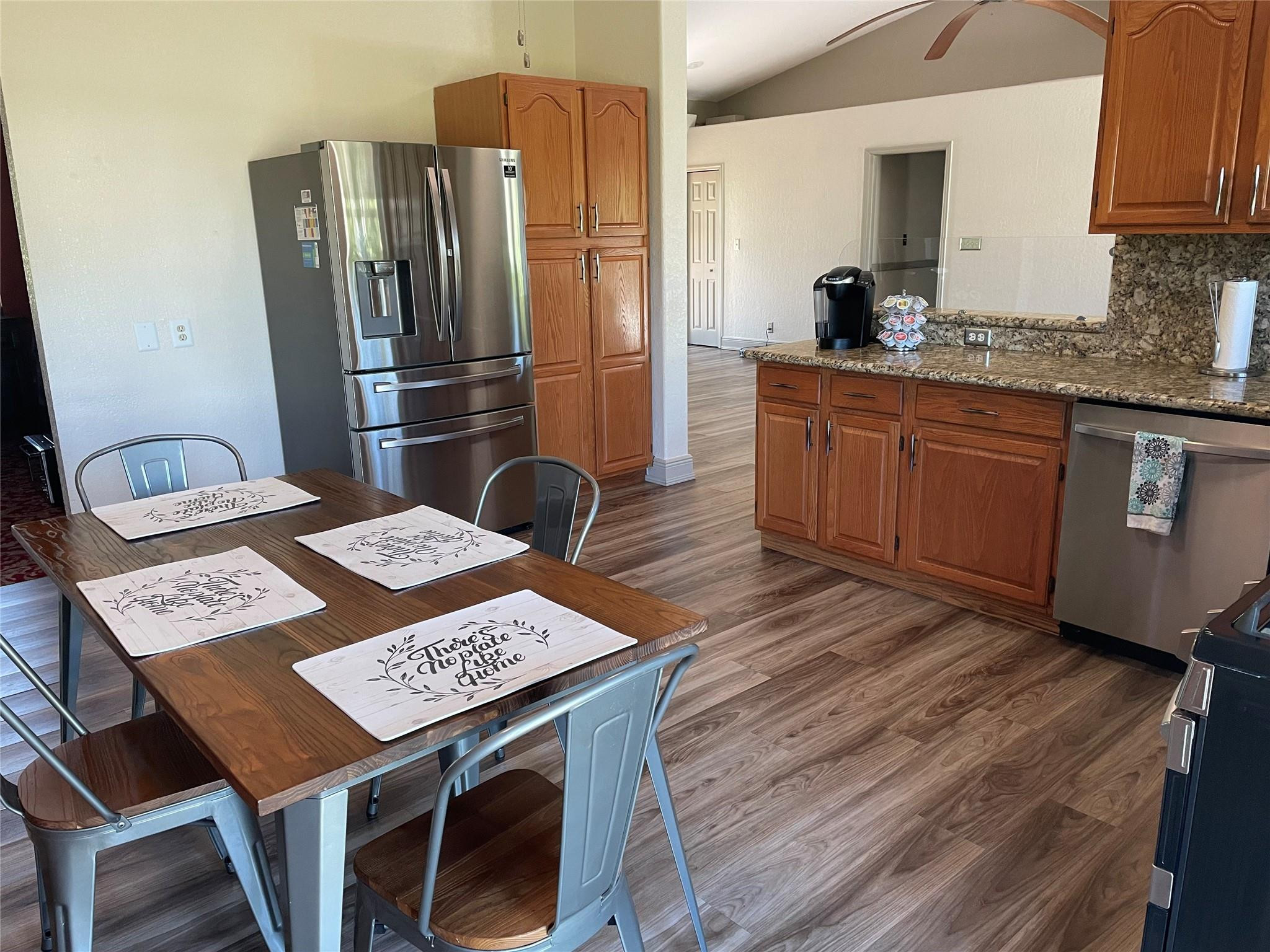 17001 Southwest 48th Street Southwest Ranches, FL 33331 - Photo 27 of 35 a kitchen with stainless steel appliances granite countertop a refrigerator a sink dishwasher a stove with wooden floor