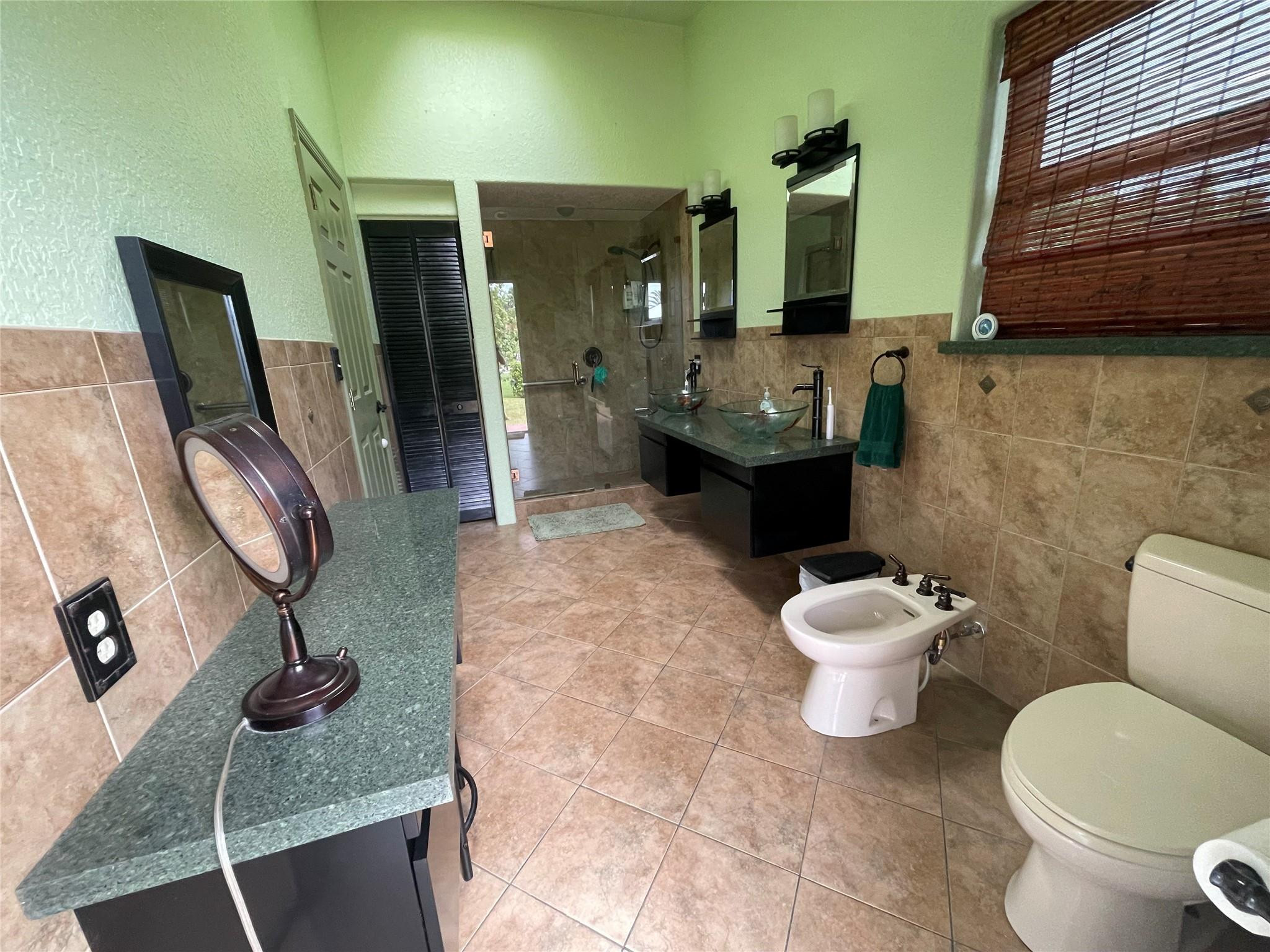 17001 Southwest 48th Street Southwest Ranches, FL 33331 - Photo 29 of 35 a bathroom with a toilet a sink and mirror