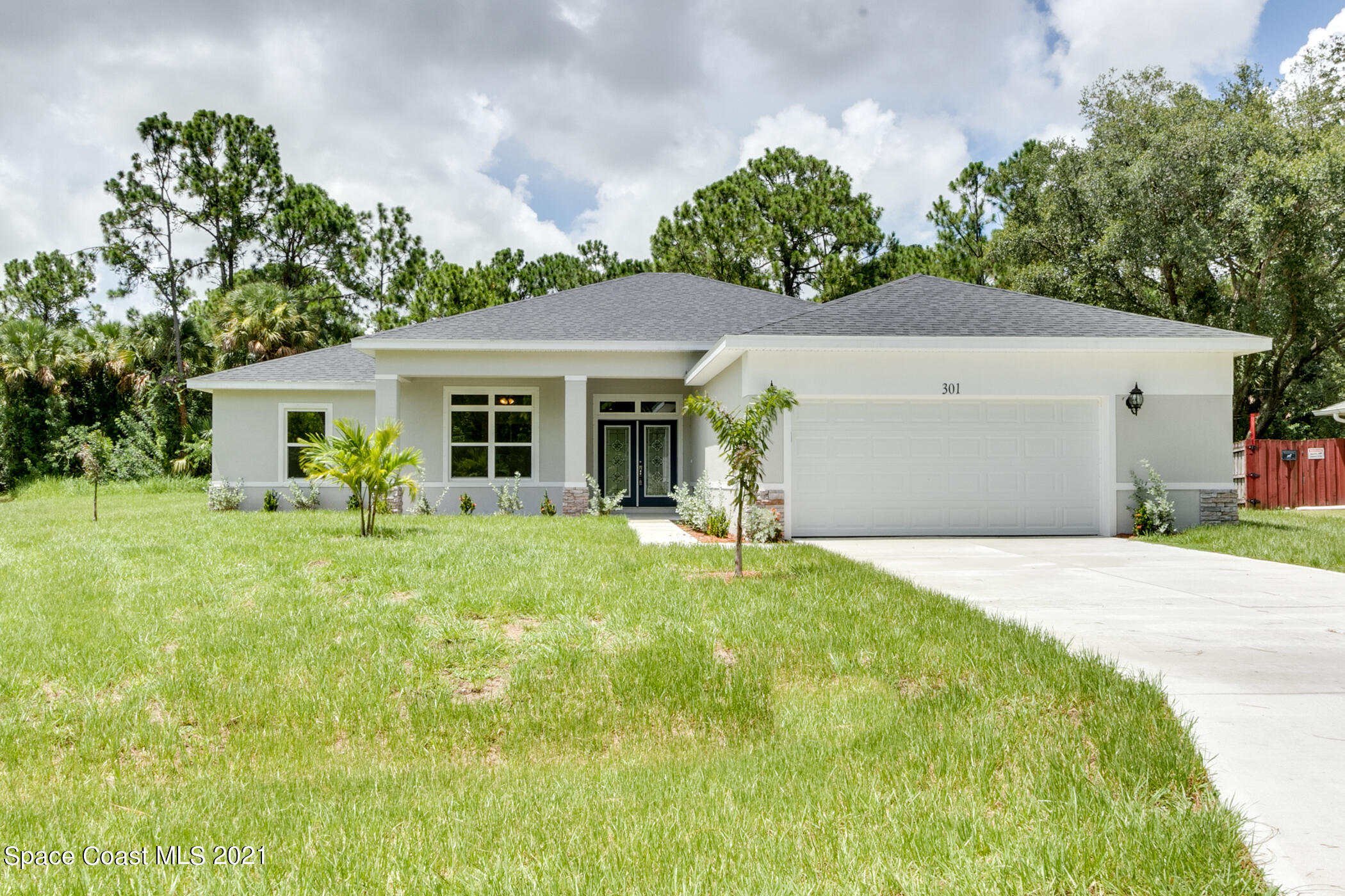 487 Abello Road Southeast, Unit 50 Palm Bay, FL 32909 - Photo 1 of 23 a front view of a house with a garden and yard