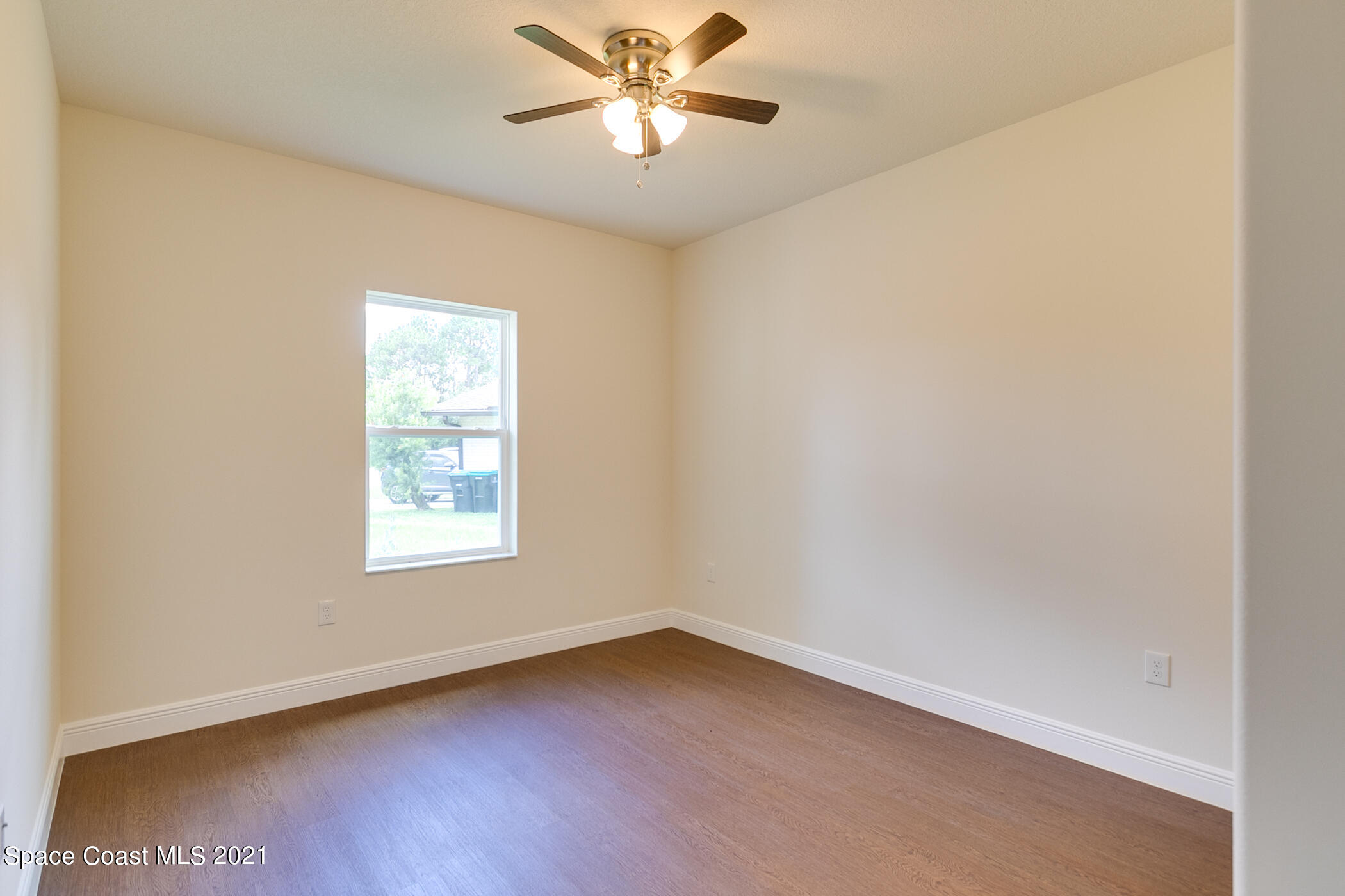 487 Abello Road Southeast, Unit 50 Palm Bay, FL 32909 - Photo 11 of 23 an empty room with a window and a fan