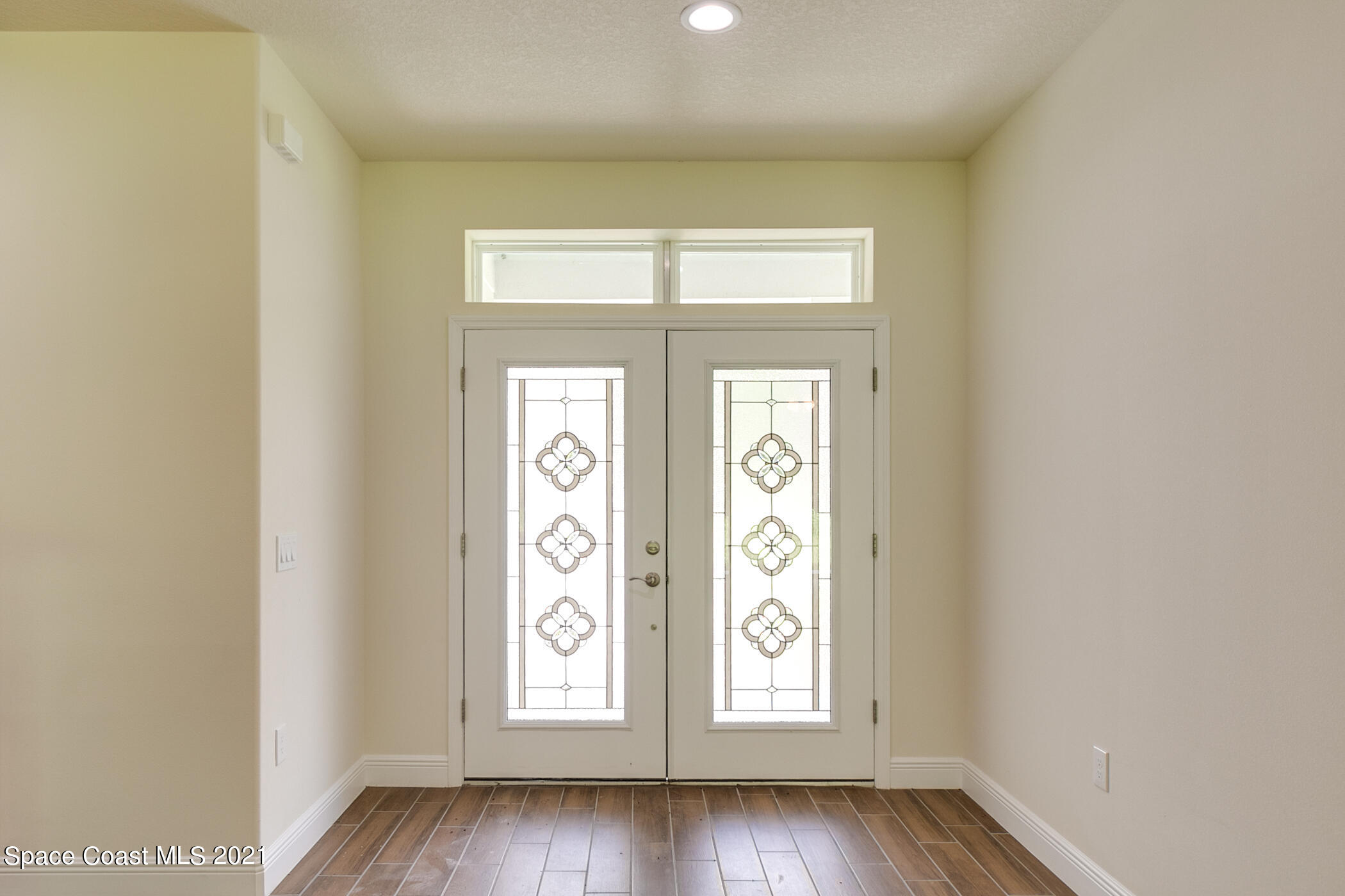 487 Abello Road Southeast, Unit 50 Palm Bay, FL 32909 - Photo 13 of 23 an empty room with wooden floor and windows
