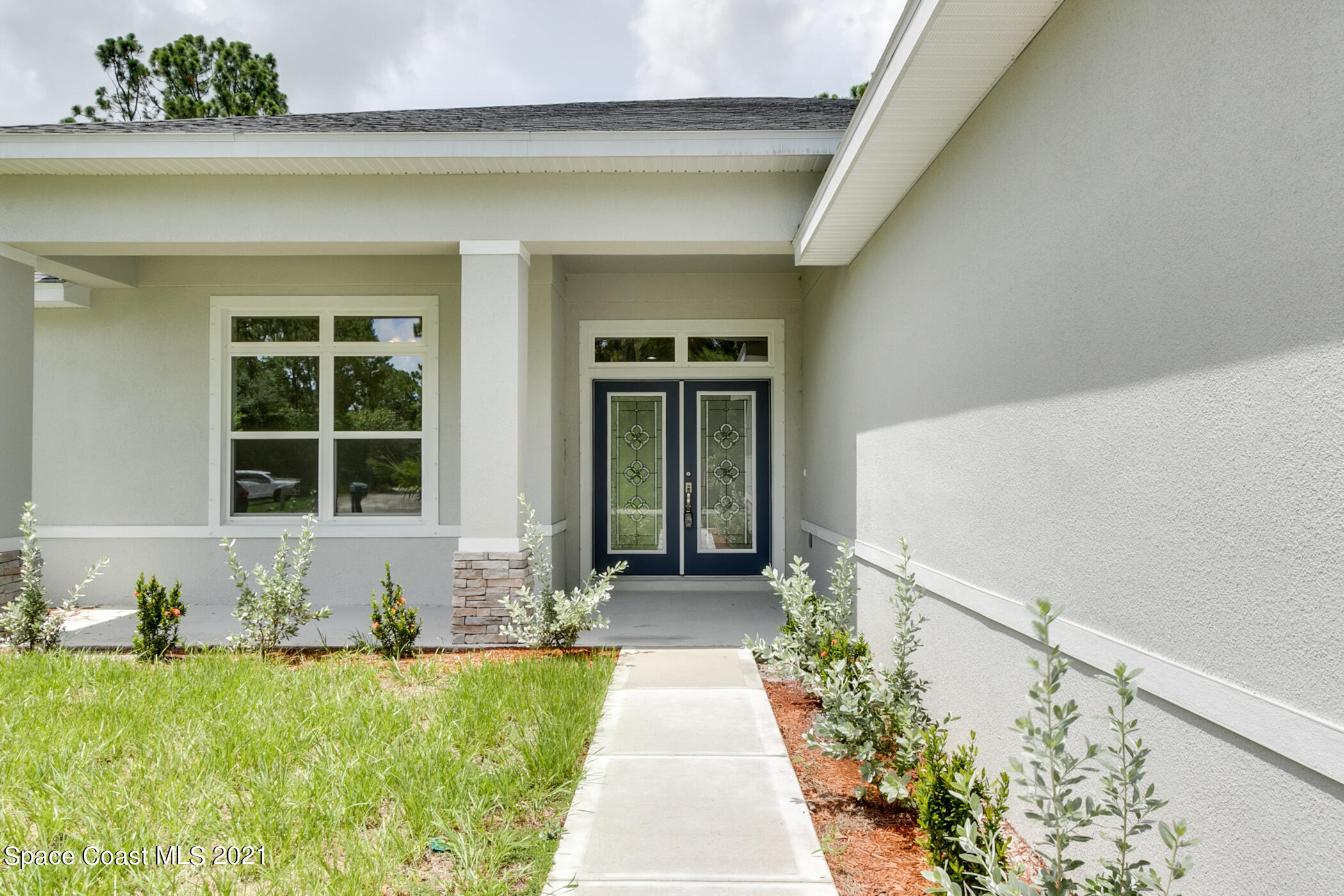 487 Abello Road Southeast, Unit 50 Palm Bay, FL 32909 - Photo 18 of 23 a front view of a house with a yard