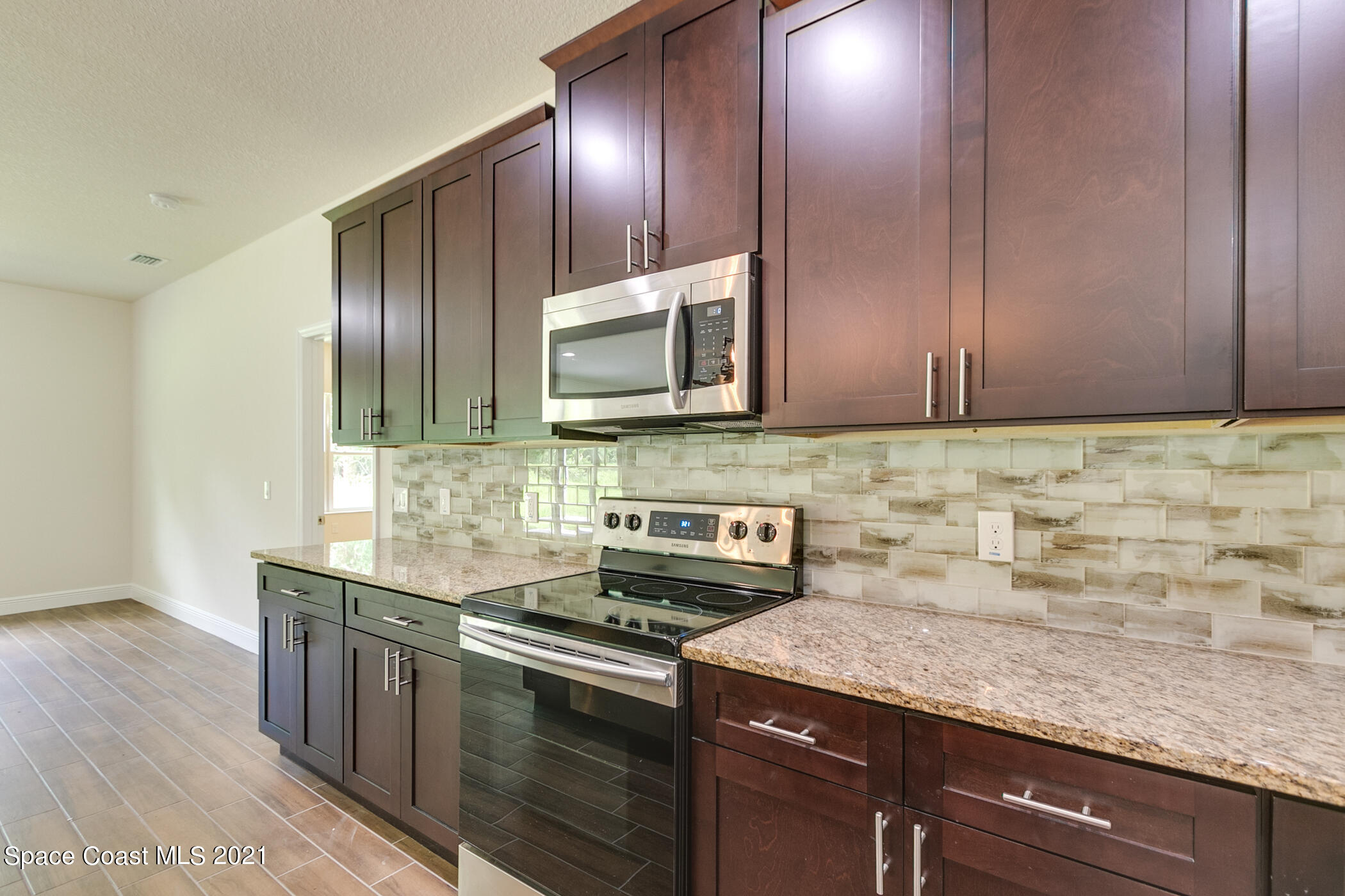 487 Abello Road Southeast, Unit 50 Palm Bay, FL 32909 - Photo 23 of 23 a kitchen with stainless steel appliances granite countertop a sink stove and microwave
