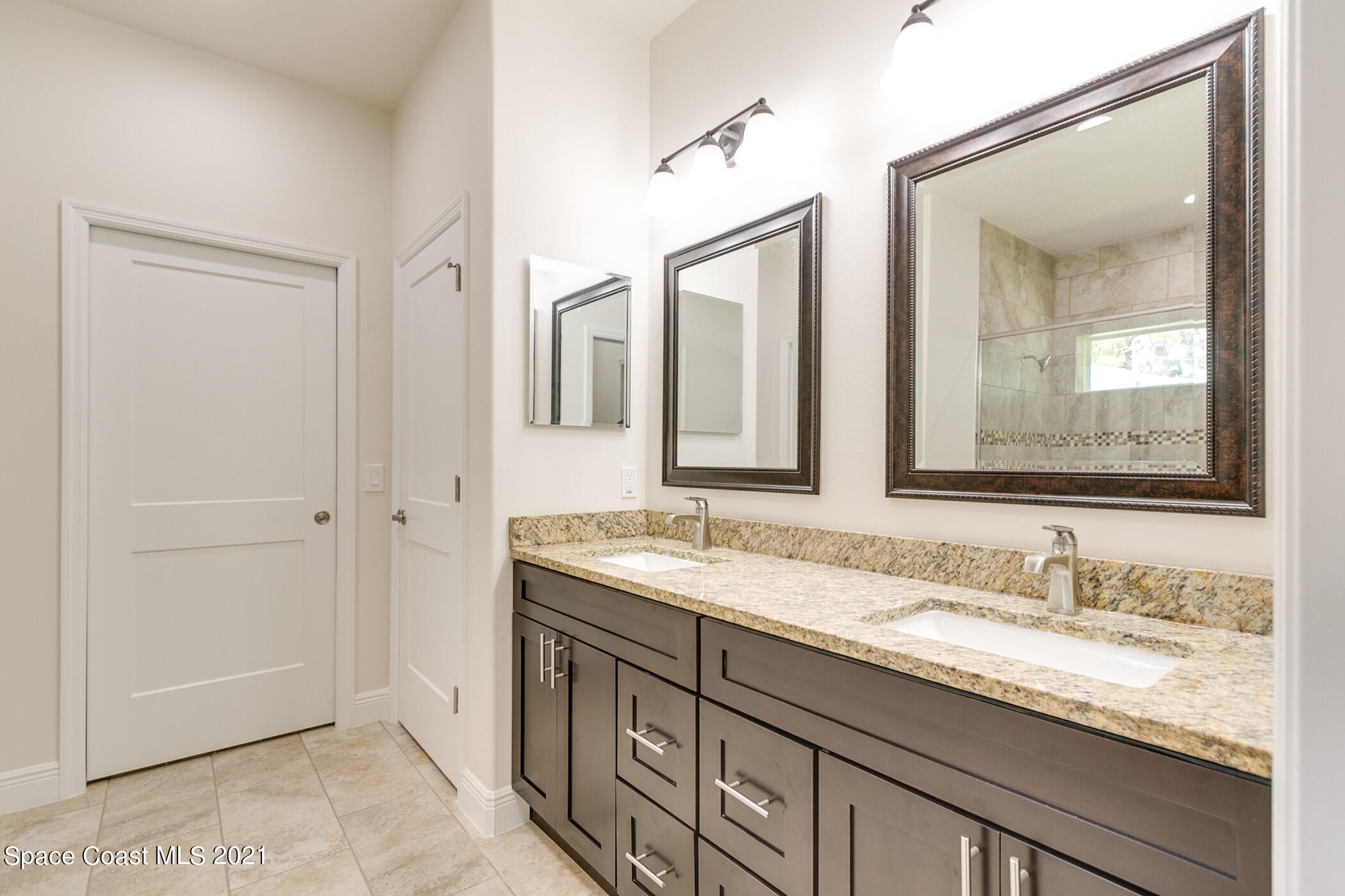 487 Abello Road Southeast, Unit 50 Palm Bay, FL 32909 - Photo 5 of 23 a bathroom with double sink and a mirror