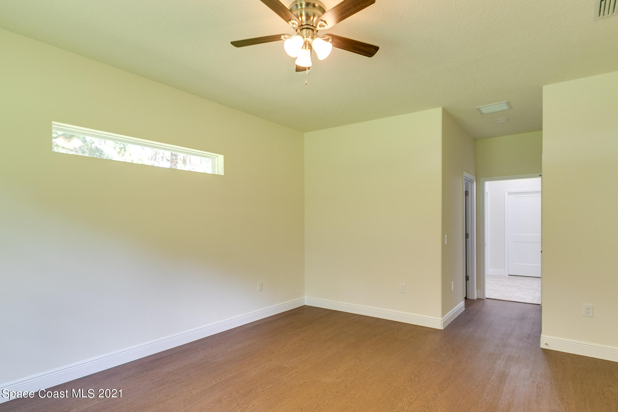 487 Abello Road Southeast, Unit 50 Palm Bay, FL 32909 - Photo 6 of 23 a view of a big room with wooden floor and closet area