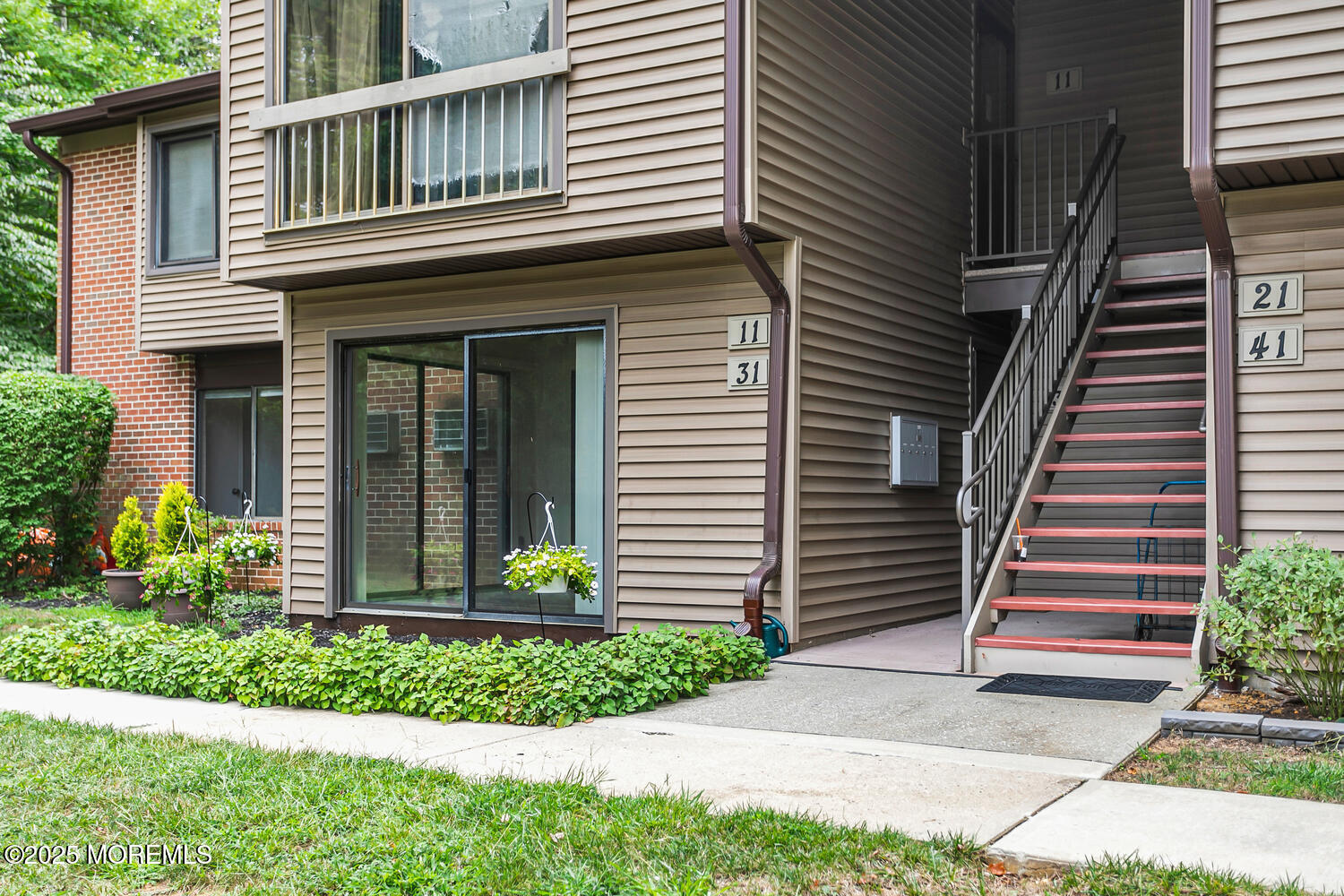 31 Hancock Court Red Bank, NJ 07701 - Photo 22 of 32 a view of a house with brick walls and a small yard