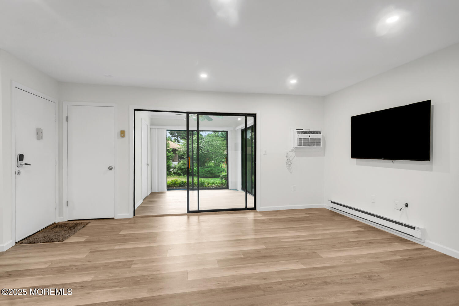 31 Hancock Court Red Bank, NJ 07701 - Photo 8 of 32 a view of an empty room with wooden floor and windows