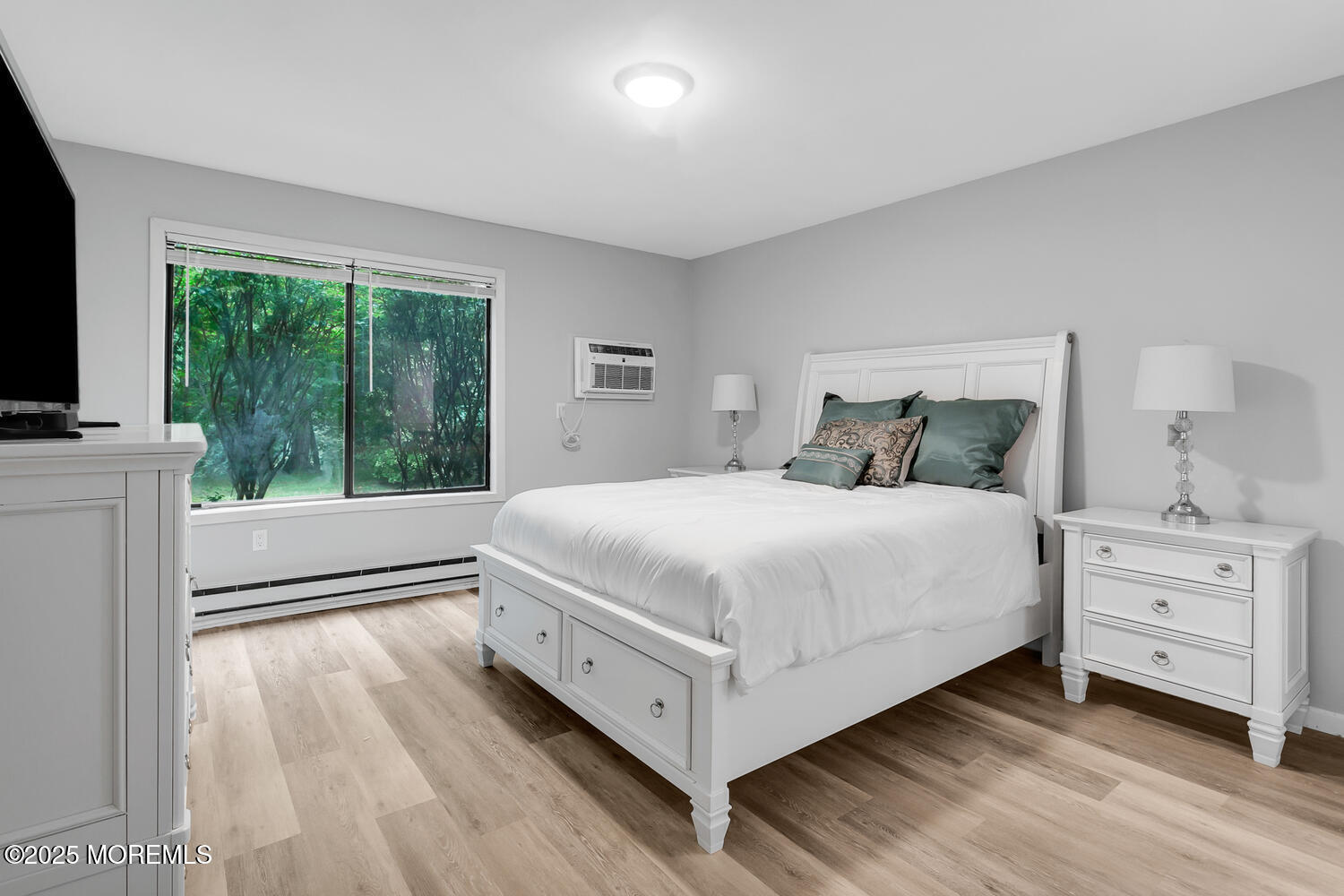 31 Hancock Court Red Bank, NJ 07701 - Photo 9 of 32 a bedroom with a bed and a flat tv screen next to a window