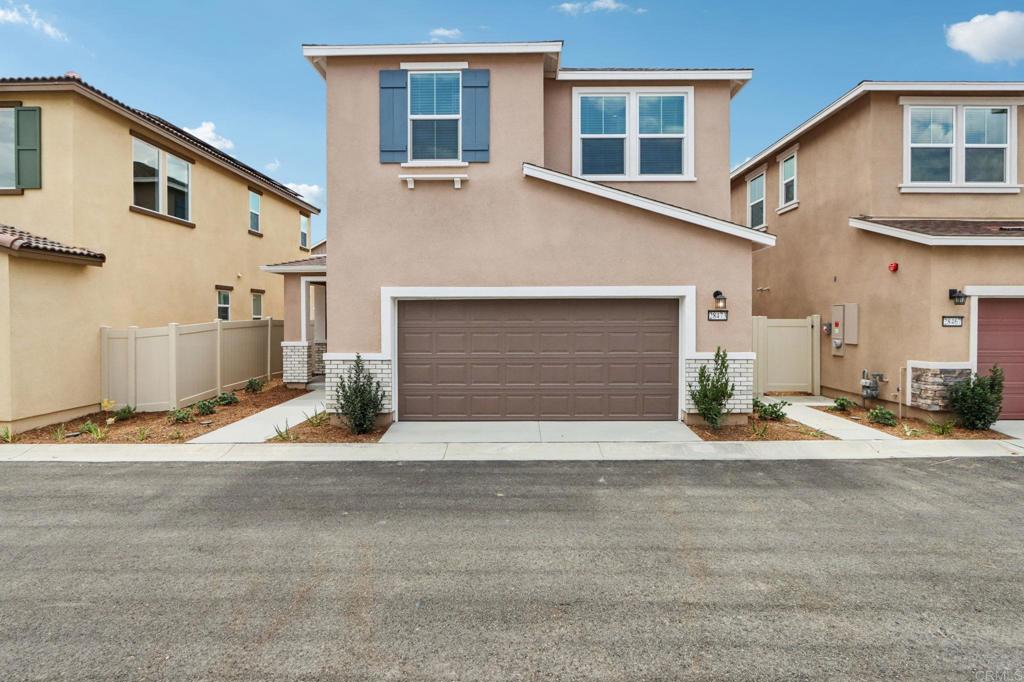a front view of a house with a yard and a garage