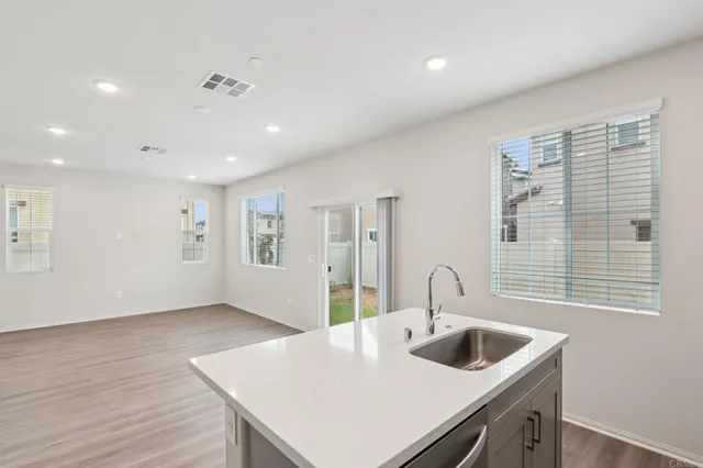 a kitchen with sink and refrigerator