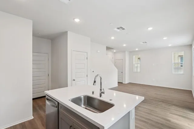 a kitchen with sink and cabinets