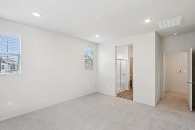 an empty room with windows and closet