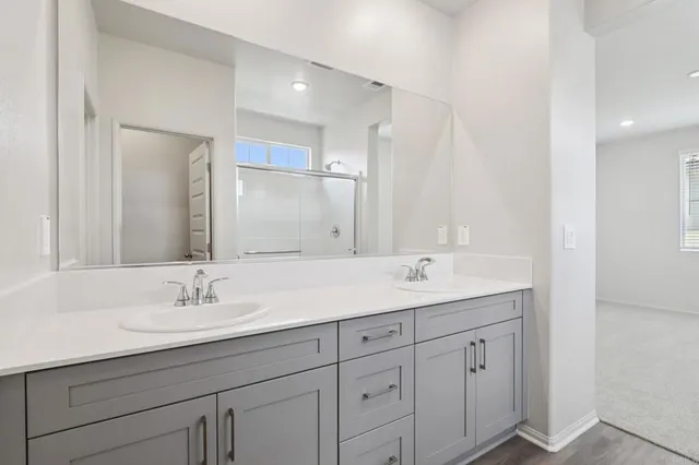 a bathroom with a shower and a glass door