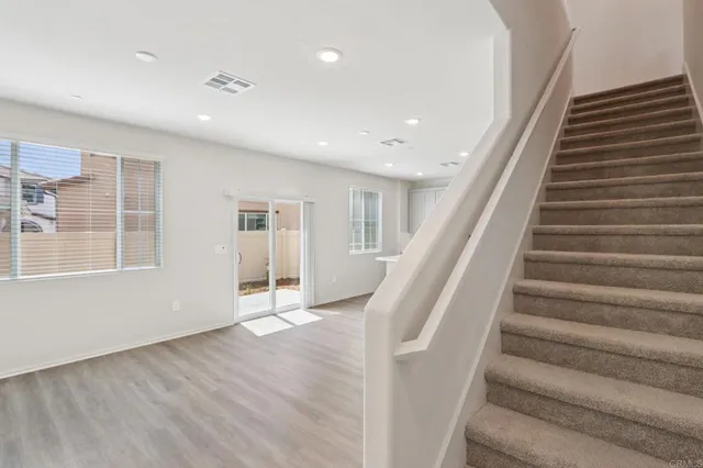 a view of staircase with white walls and windows