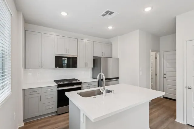 a kitchen with a sink a stove and refrigerator