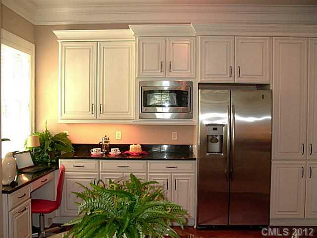 2823 Providence Road, Unit 312 Charlotte, NC 28211 - Photo 12 of 16 a kitchen with stainless steel appliances granite countertop a refrigerator and a stove