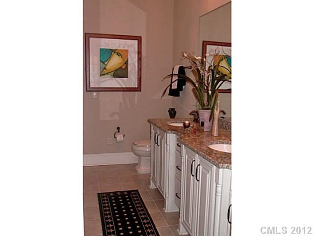 2823 Providence Road, Unit 312 Charlotte, NC 28211 - Photo 10 of 16 a bathroom with a sink a toilet and mirror