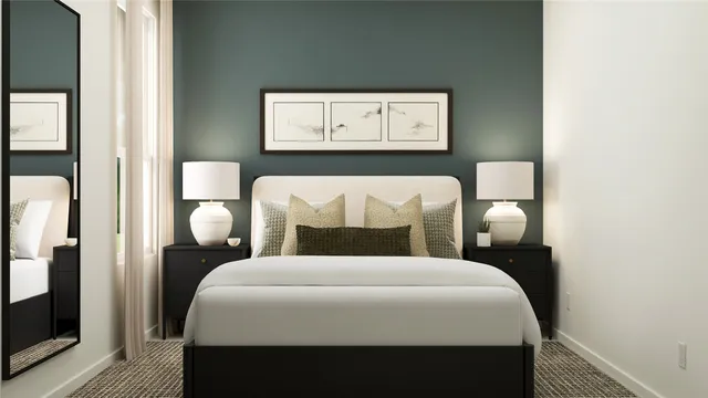 a bedroom with a bed and a painting on the wall