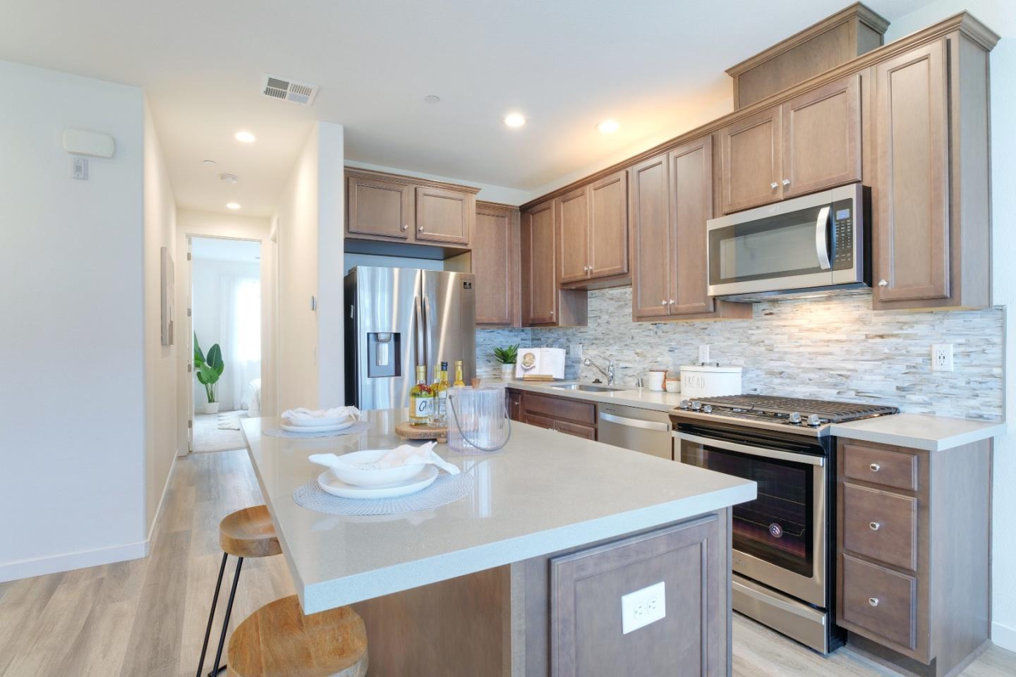 1888 Joshua Tree Circle Milpitas, CA 95035 - Photo 16 of 50 a kitchen with a stove a sink and a refrigerator
