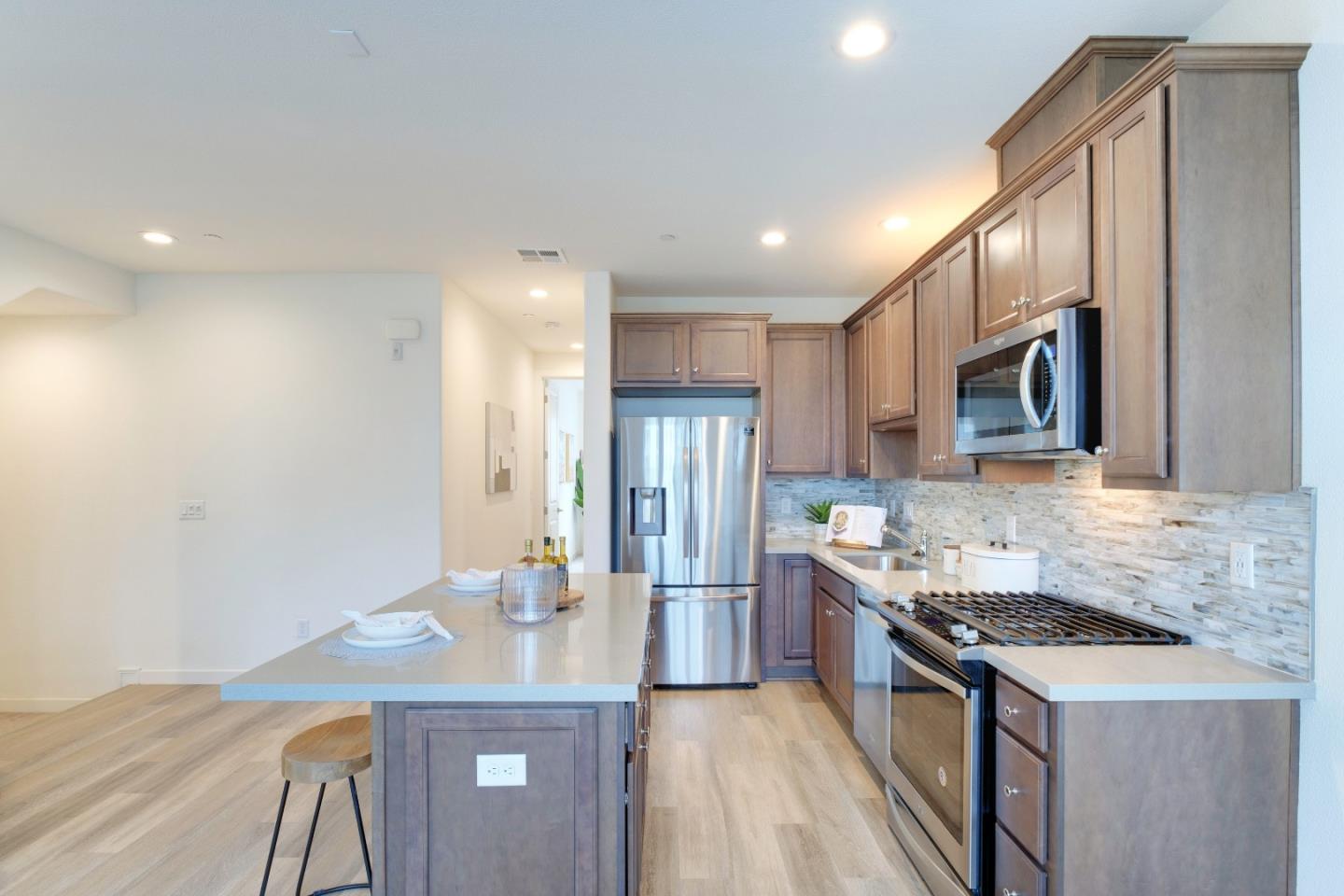 1888 Joshua Tree Circle Milpitas, CA 95035 - Photo 17 of 50 a kitchen with stainless steel appliances granite countertop a sink stove and refrigerator