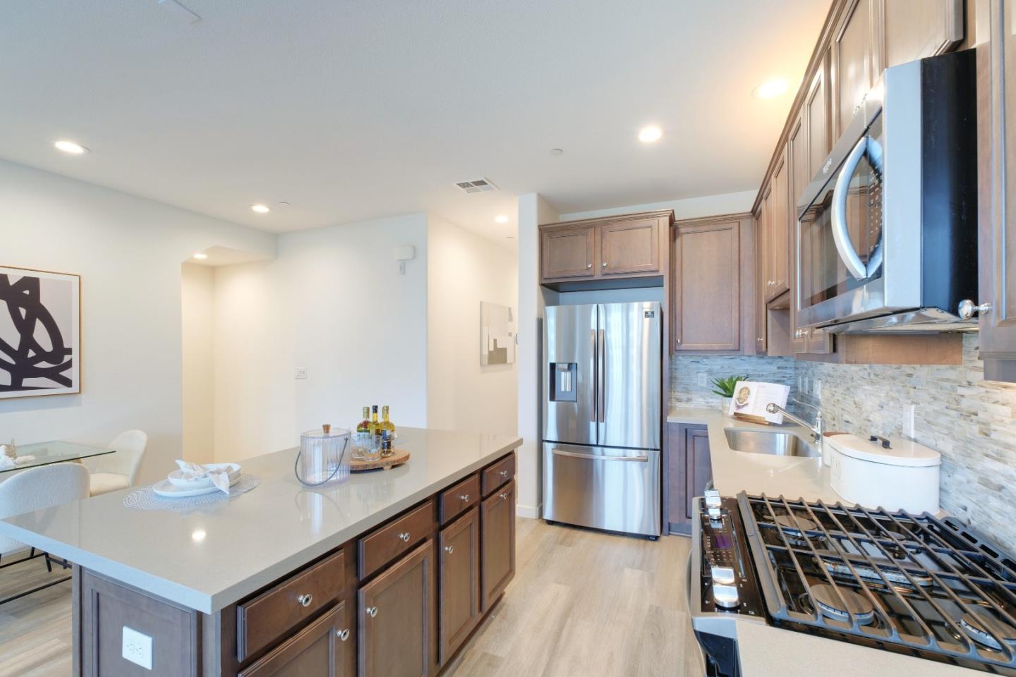 1888 Joshua Tree Circle Milpitas, CA 95035 - Photo 18 of 50 a kitchen with stainless steel appliances a sink stove and refrigerator