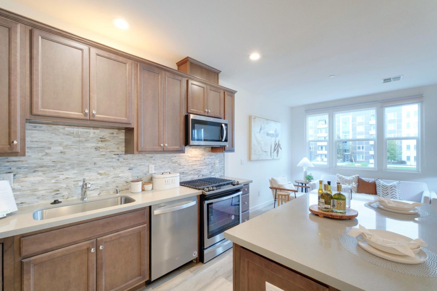 1888 Joshua Tree Circle Milpitas, CA 95035 - Photo 19 of 50 a kitchen with stainless steel appliances granite countertop a sink a stove and white cabinets