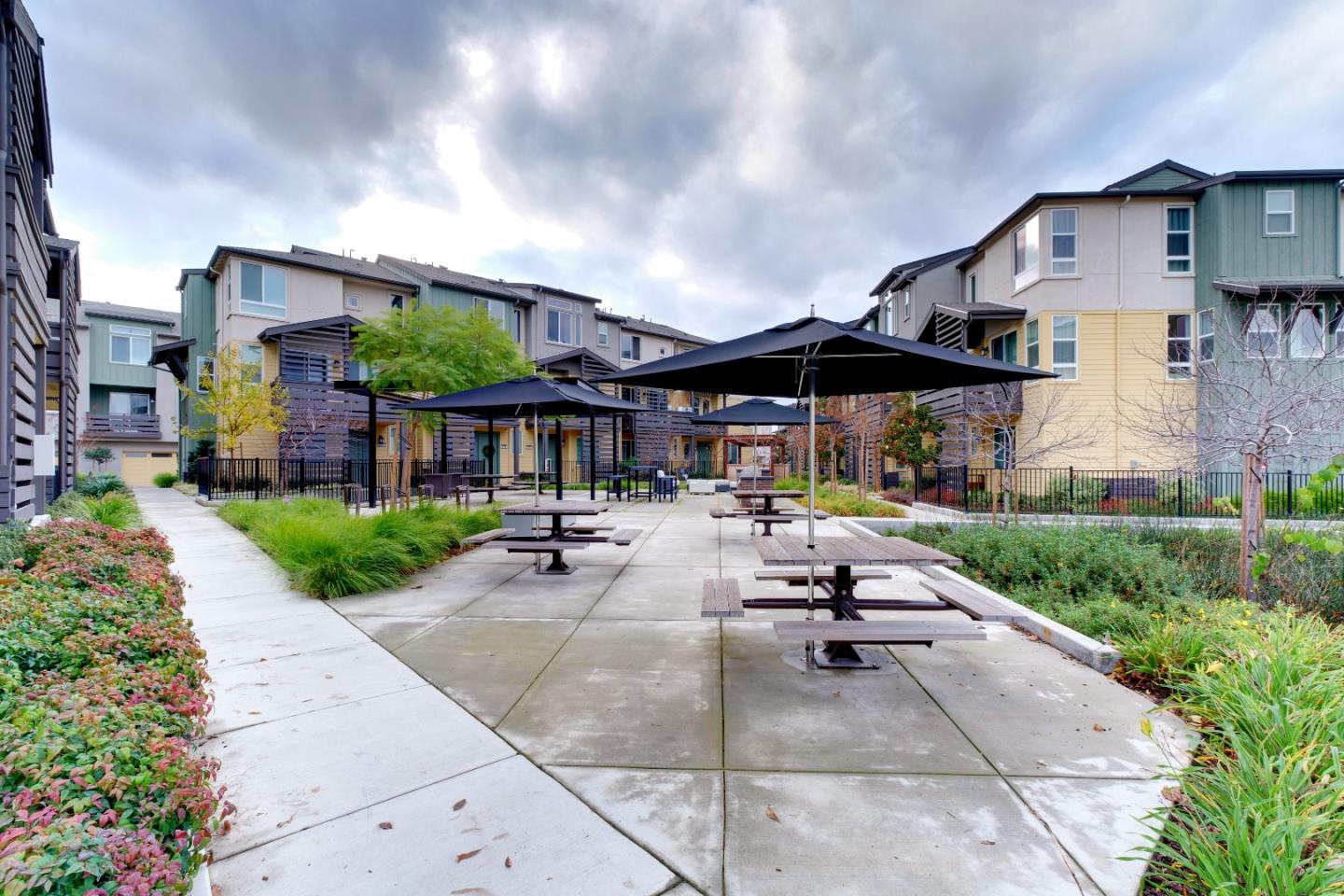1888 Joshua Tree Circle Milpitas, CA 95035 - Photo 42 of 50 a view of a patio with a table and chairs under an umbrella
